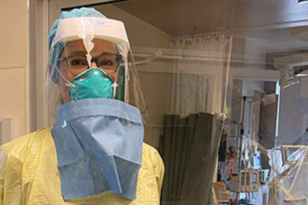 A women wearing scrubs and personal protection equipment